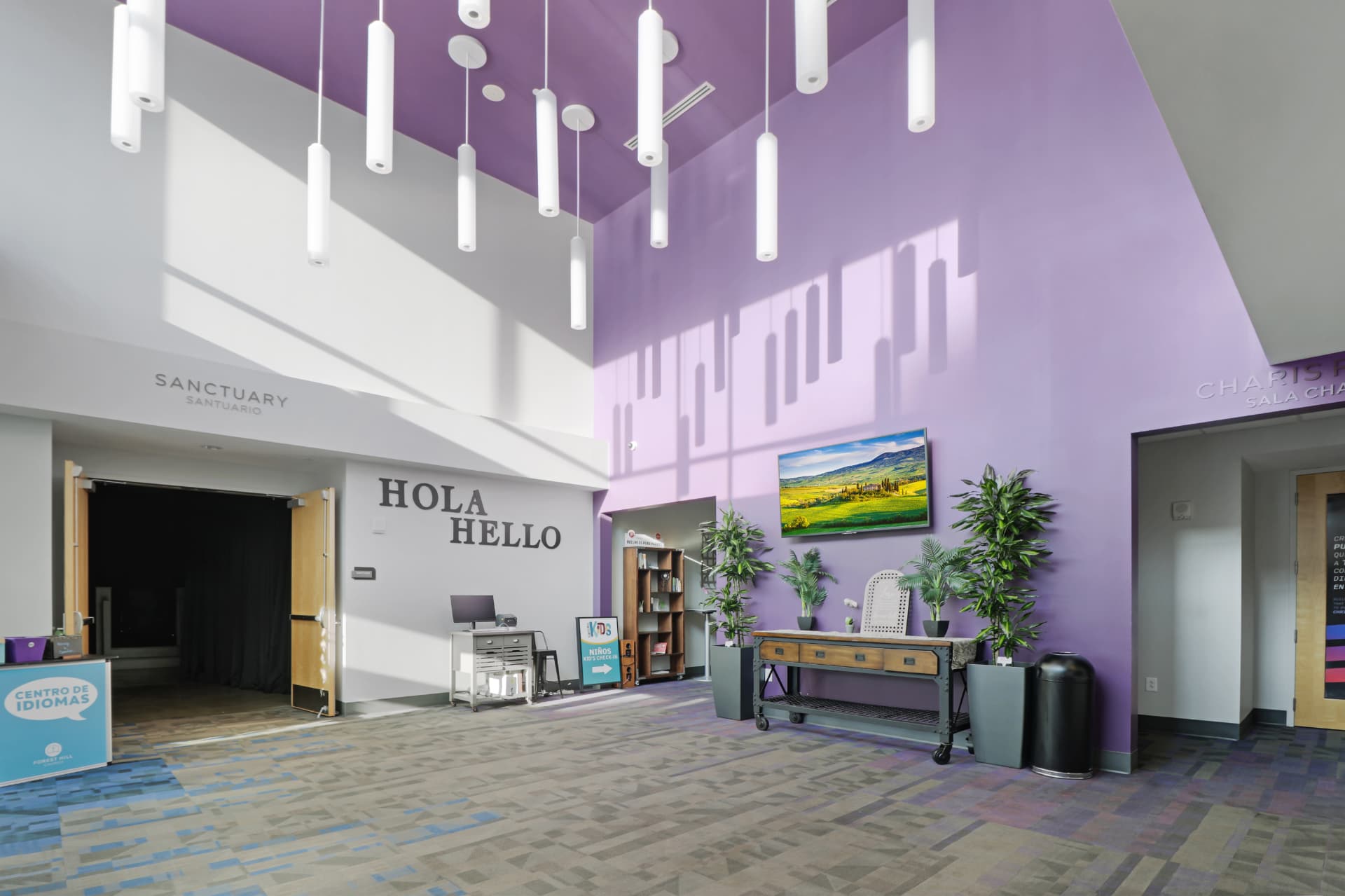 Double-height lobby with bilingual wayfinding signage