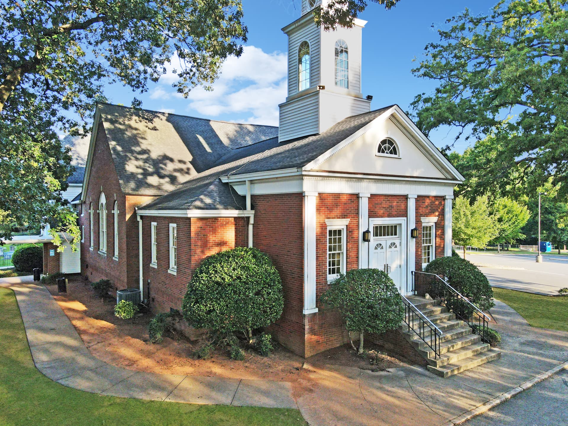 Brick chapel with white steeple at 6210 Old Pineville Road