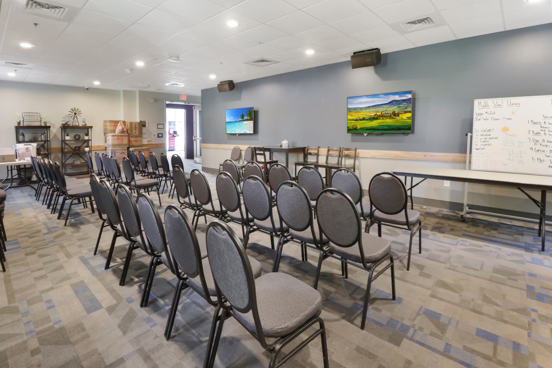 Multipurpose classroom with seating, tables, and displays