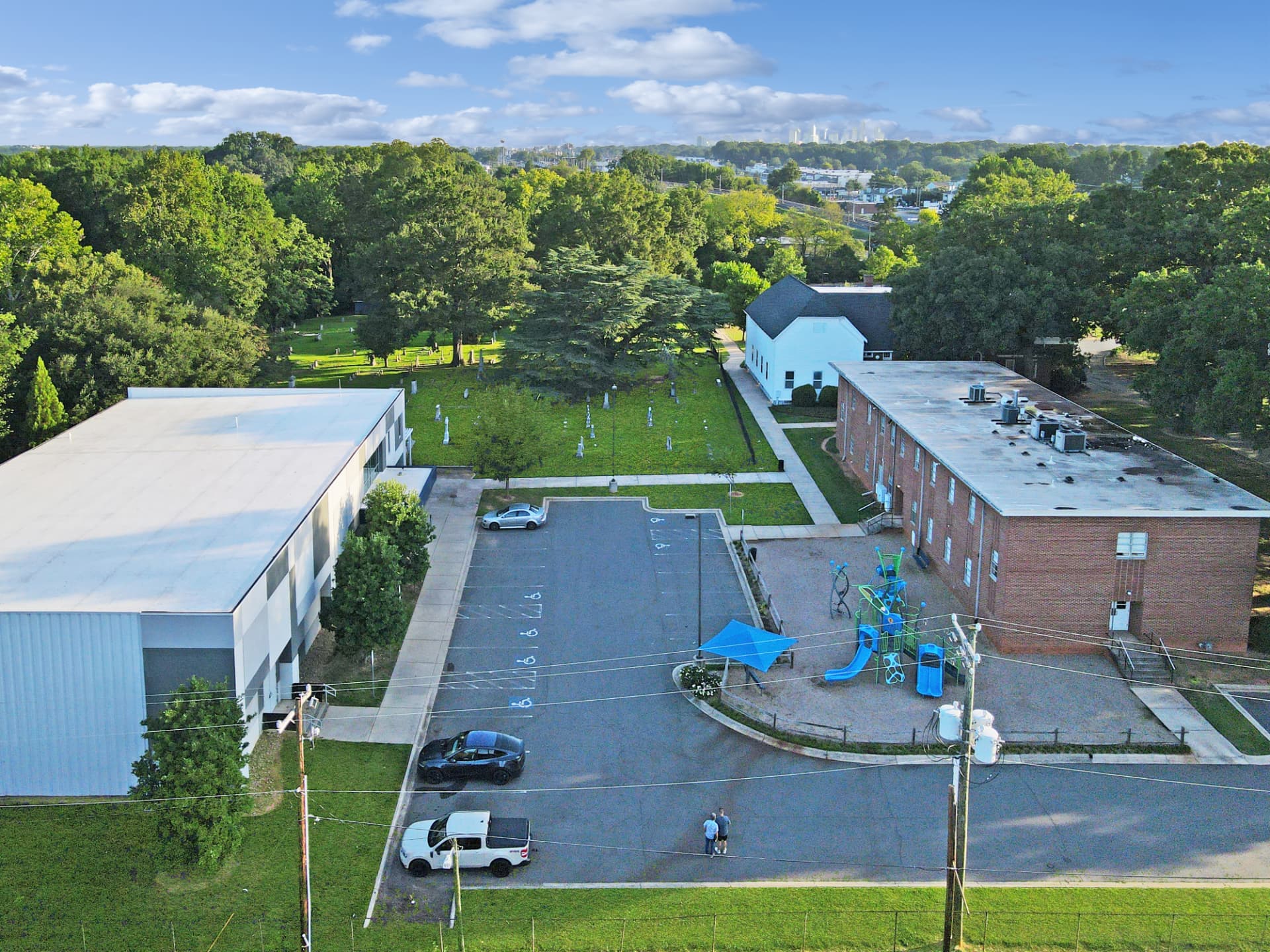 Overhead view of the three-building campus and cemetery
