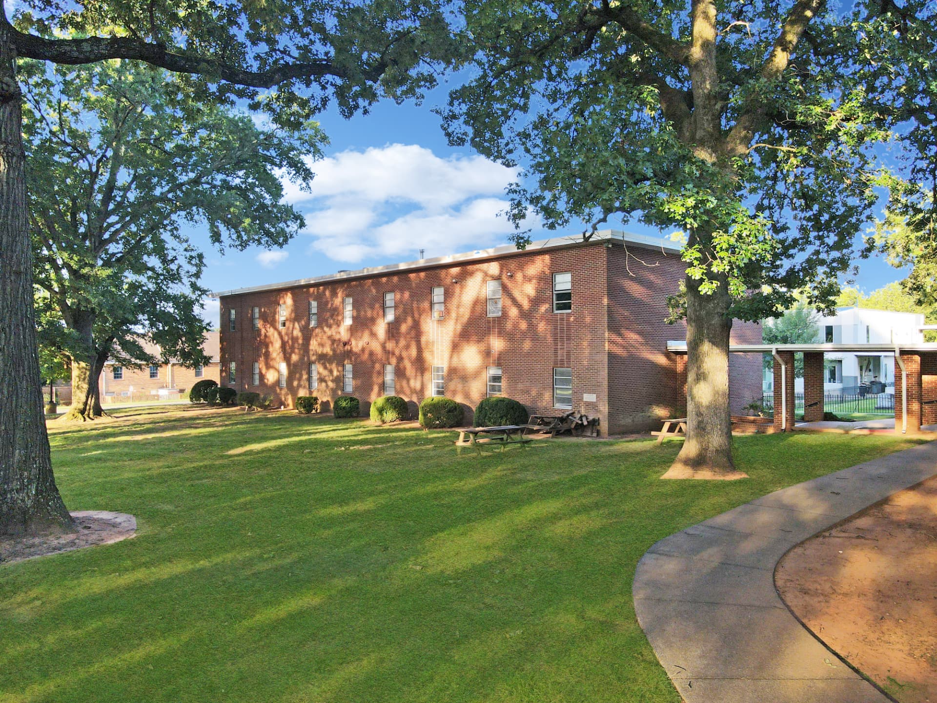 Shaded lawn and picnic area beside the education building